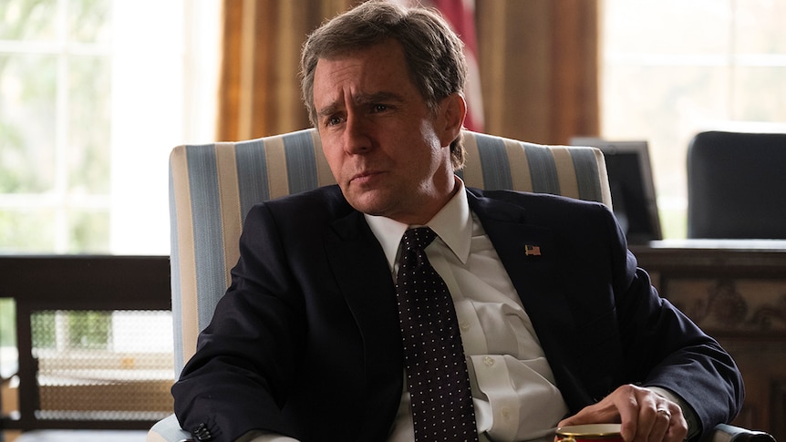 Colour still of Sam Rockwell seated in the oval office in 2018 film Vice.