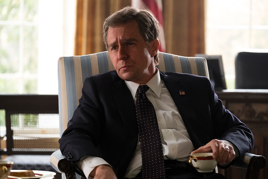 Colour still of Sam Rockwell seated in the oval office in 2018 film Vice.