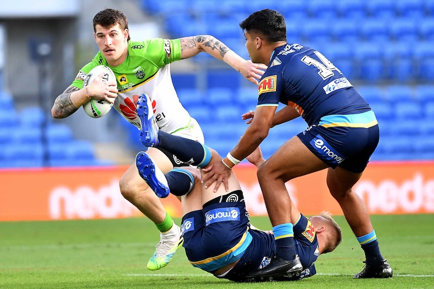 Rugby league players from two teams in play.