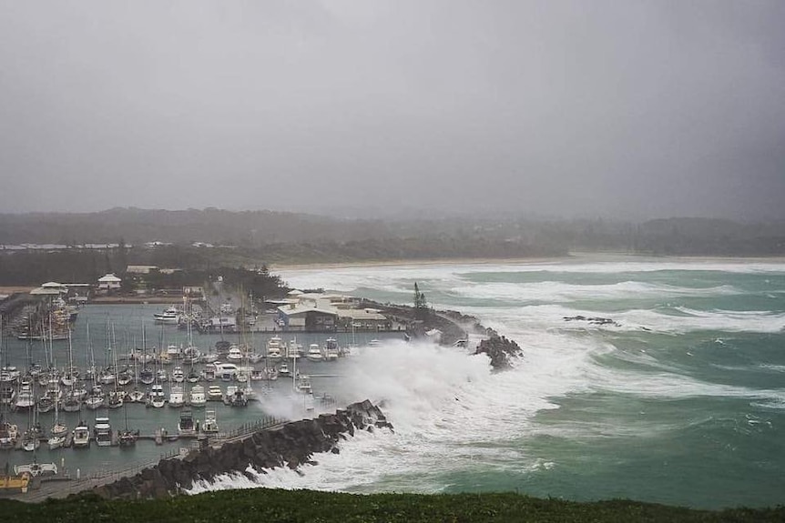 Heavy seas  pound the breakwall in Coffs Harbour.