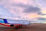 red, white and blue jet on the tarmac in Broome