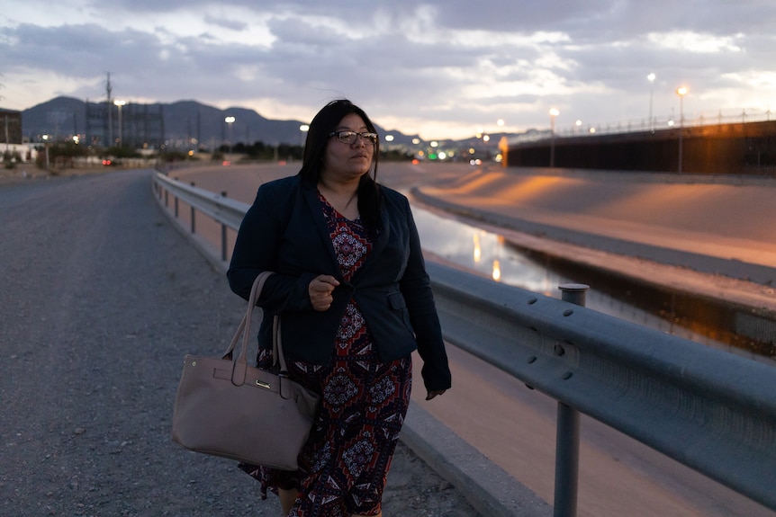 Keldy walks near the border wall at Ciudad Juárez.