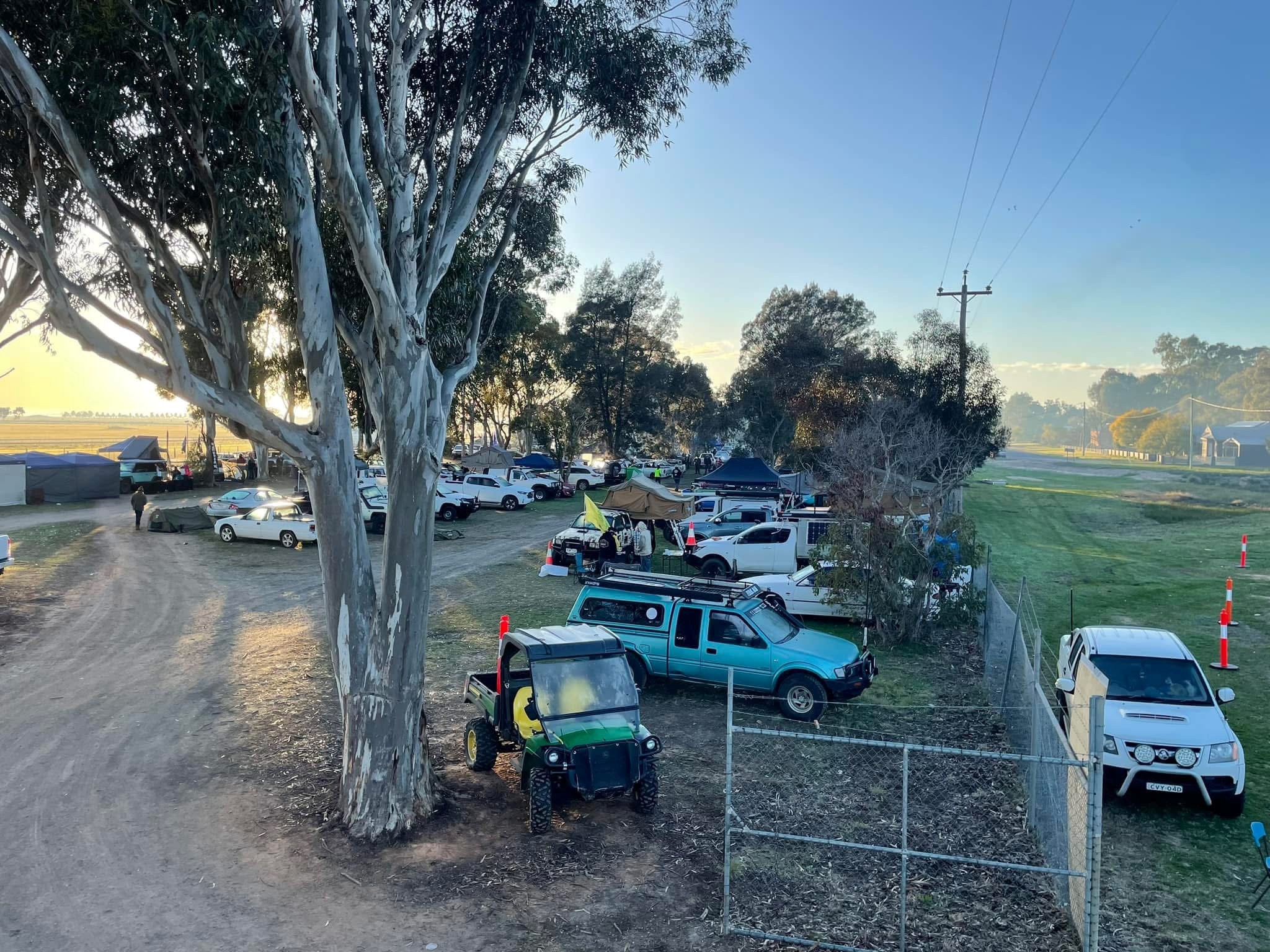 An array of utes and swag parked at a racecourse carpark