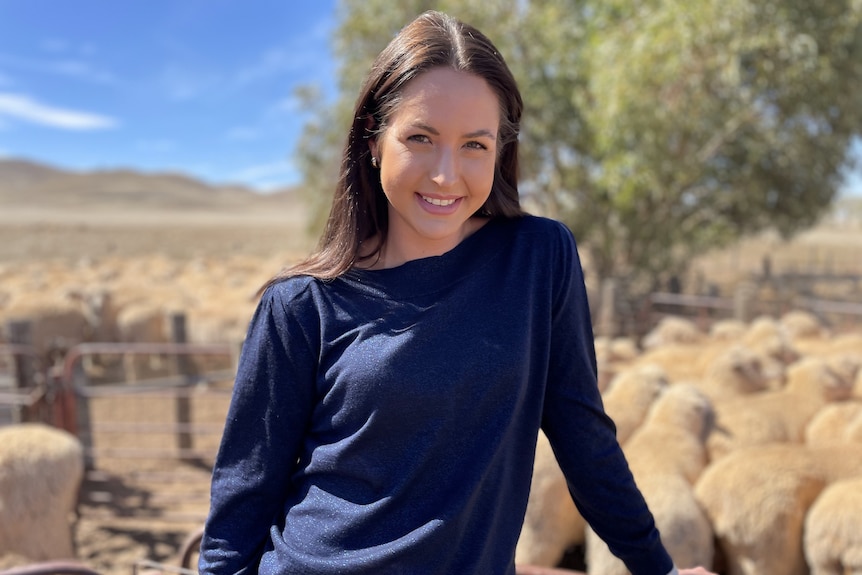 Photo of a woman in a blue jumper.