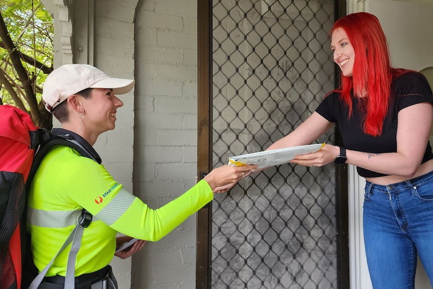 Postie delivers mail to woman at her door