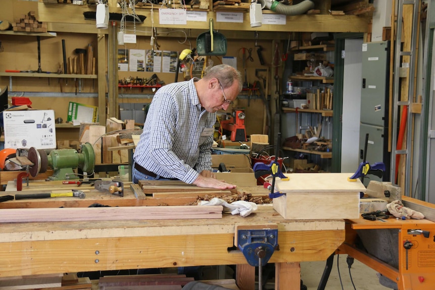 A man works in the Majura Men's Shed.