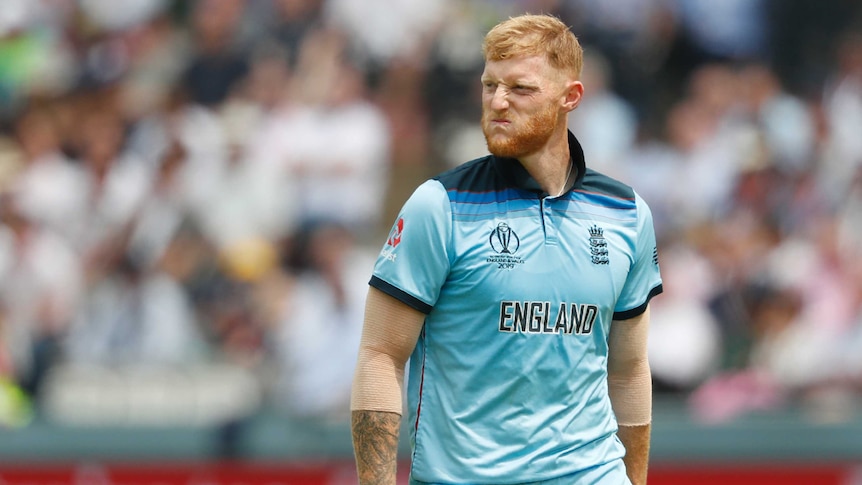 Ben Stokes scrunches up his face in as he walks at Lord's in light blue cricket kit