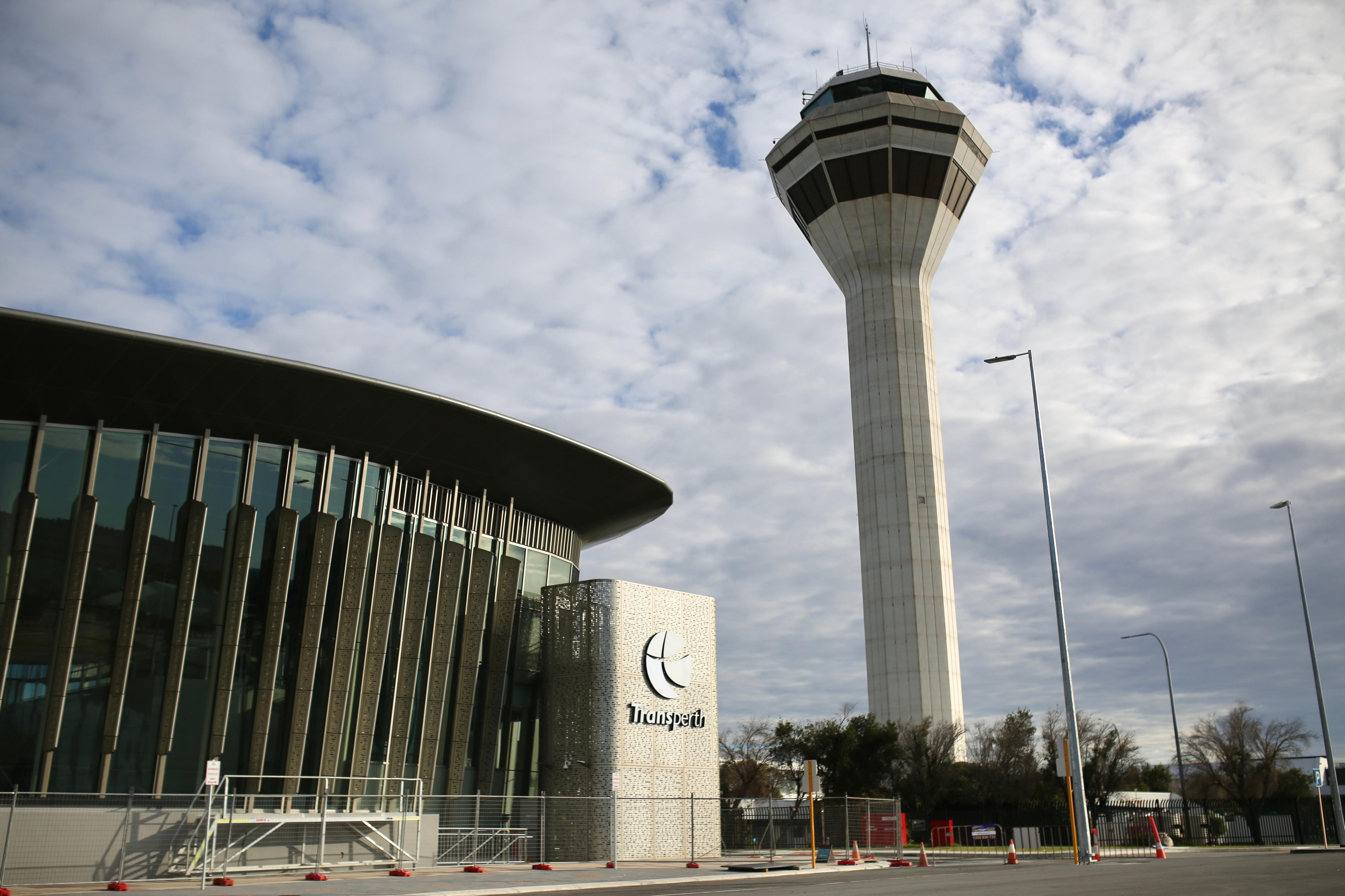 The exterior of Perth Airport's train station in the foreground with the air traffic control tower in the background. 