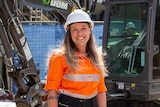 A woman smiling on construction site.