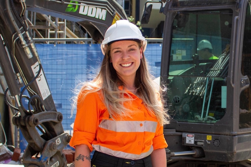 A woman smiling on construction site.