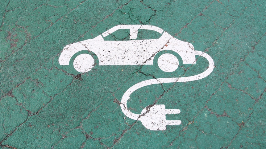 A white plogo of a car witha  power plug on a gree background. 