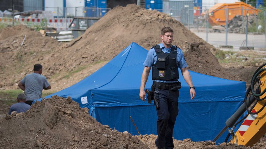 Officers visit the construction site where the bomb was discovered
