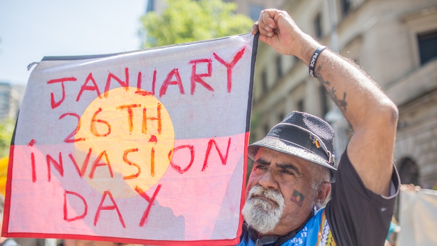An indigenous man joined the rally outside Melbourne's Parliament House.