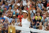 Johanna Konta waves to the Wimbledon crowd after beating Simona Halep.