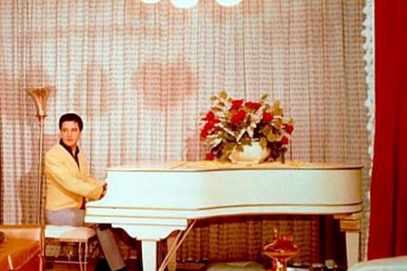 Elvis Presley sits at his white Knabe grand piano
