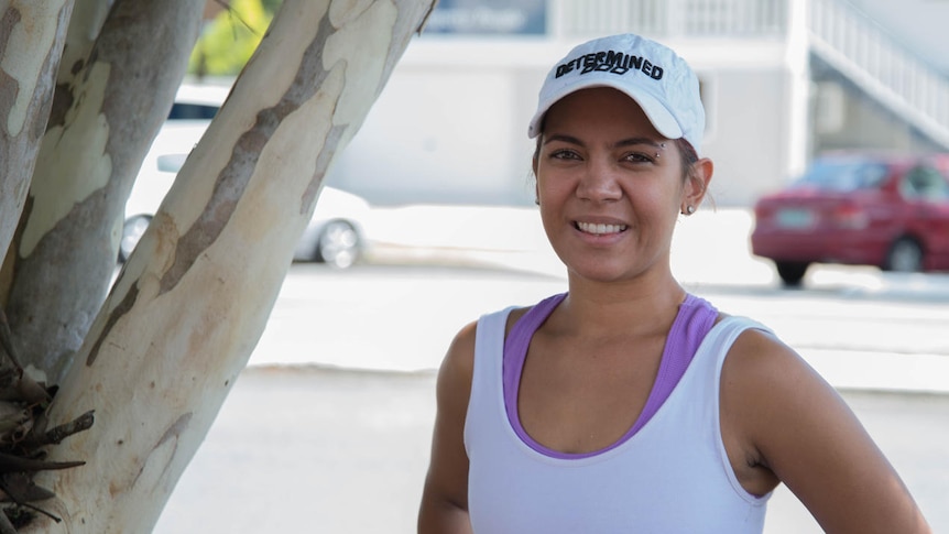 Portrait photo of a young Indigenous woman in athletic gear