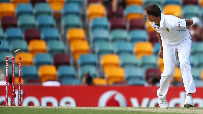 Dale Steyn watches the ball hit the stumps as he runs out Australian batsman Ed Cowan