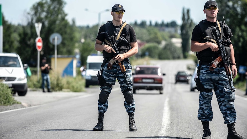 Pro-Russian militants block the road and stop Dutch and Australian forensic teams from reaching the crash site of MH17.