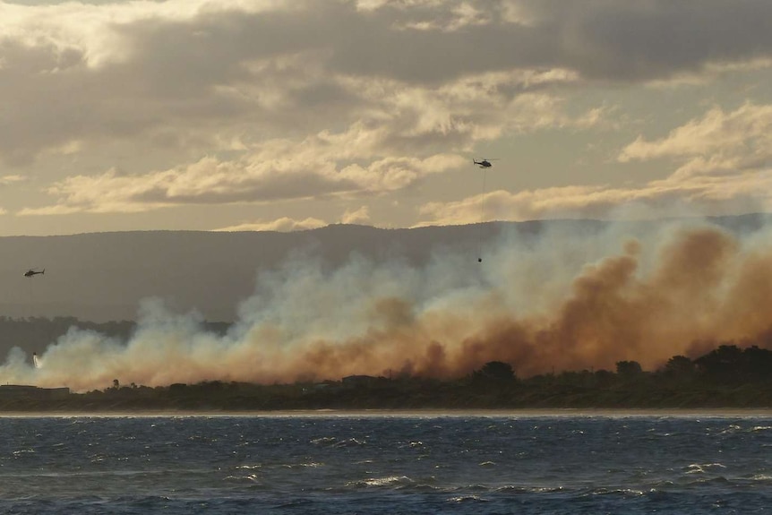 Waterbombing helicopters over Dolphin Sands fire