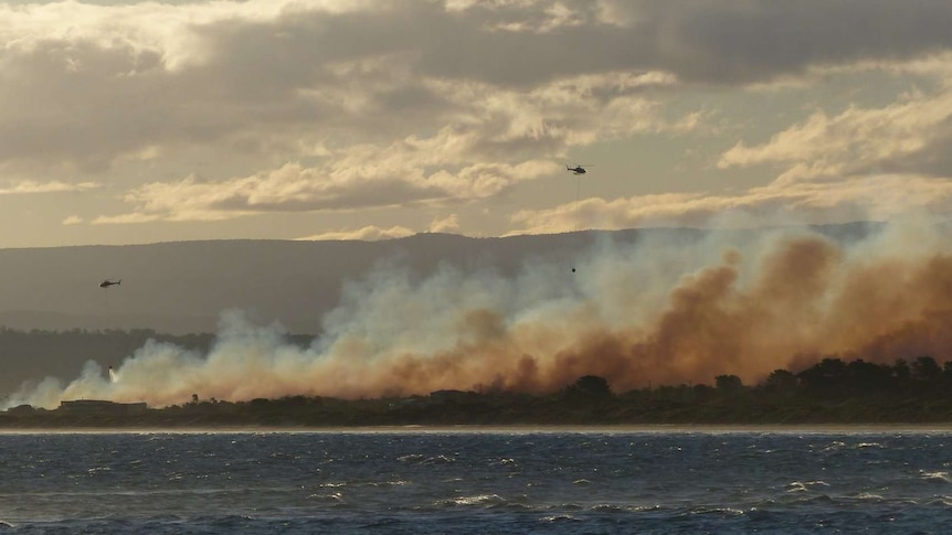 Waterbombing helicopters over Dolphin Sands fire