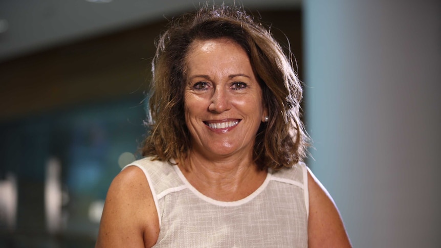 Profile photo of a woman smiling at the camera.