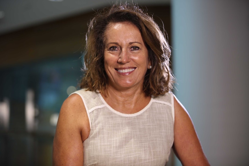 Profile photo of a woman smiling at the camera.