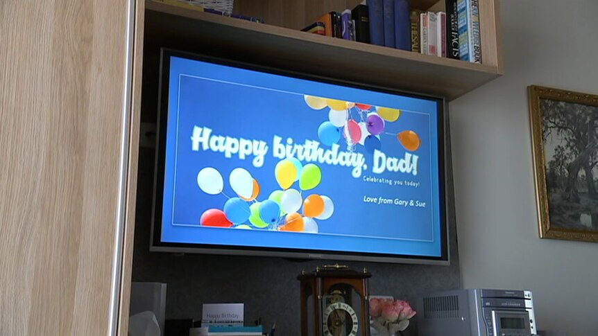 A happy birthday message displayed on a TV screen