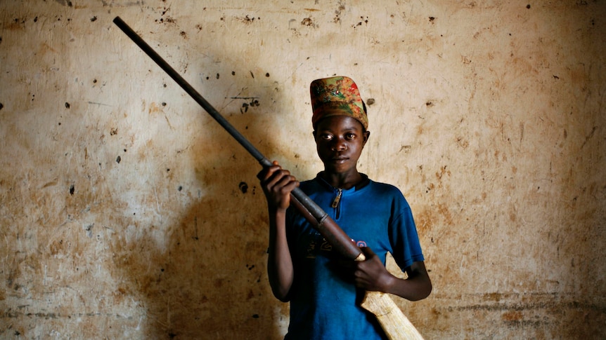 Congolese boy with homemade rifle