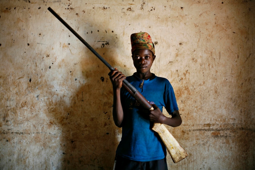 Congolese boy with homemade rifle