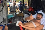 Shark victim on stretcher inside rescue helicopter.