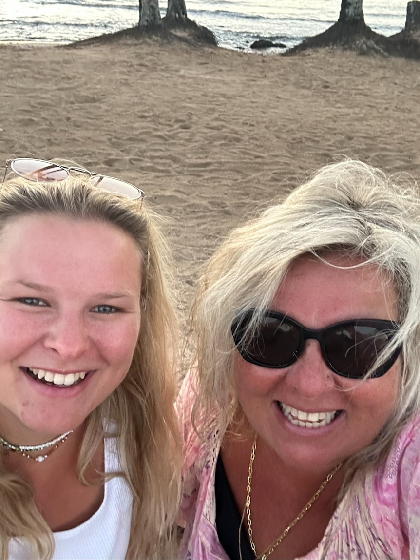 Lisa Evans and her daughter smiling in a selfie photo taken at the beach.