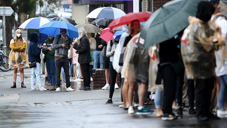 People are seen queuing outside a Centrelink office in Bondi Junction, Sydney, Tuesday, March 24, 2020.