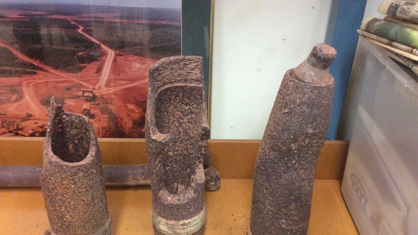 World War II era rusted bomb casings taken by police for examination.