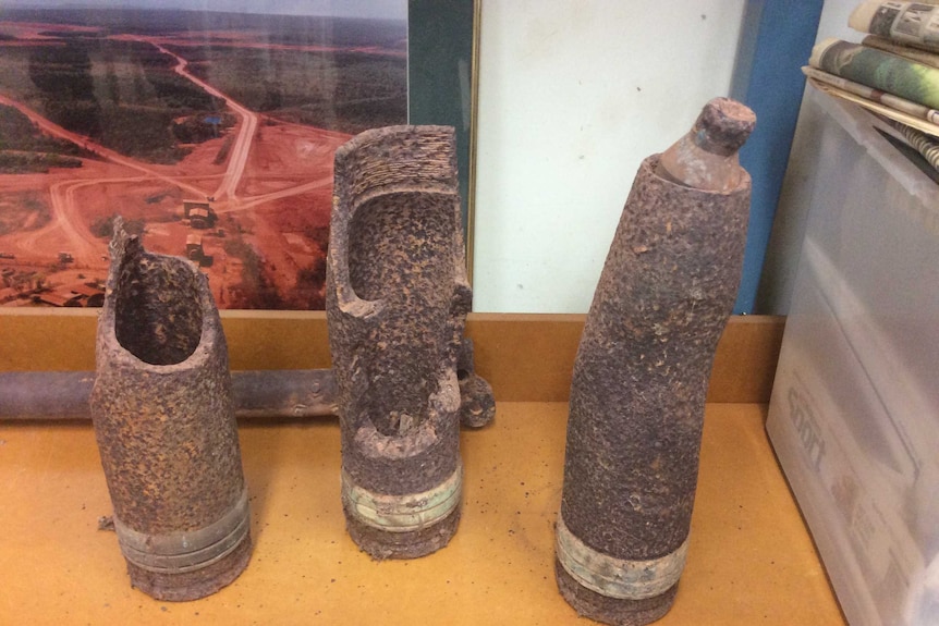 World War II era rusted bomb casings taken by police for examination.