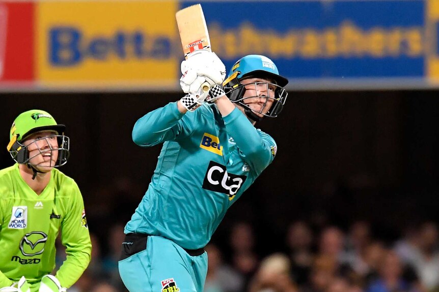 Matt Renshaw completes a big follow-through with his bat during a Big Bash League game against the Sydney Thunder.