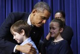 Obama hugs a boy while announcing gun control proposals