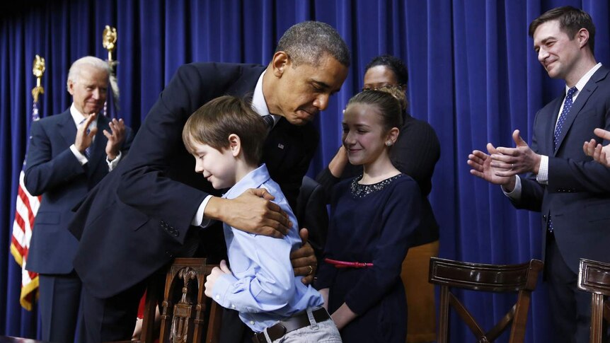 Obama hugs a boy while announcing gun control proposals