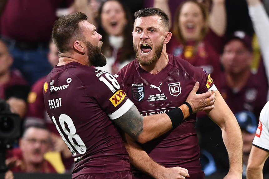 Kurt Capewell is hugged by Queensland Maroons teammate Kyle Feldt after scoring a State of Origin try.