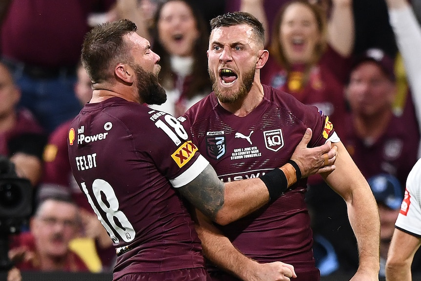 Kurt Capewell is hugged by Queensland Maroons teammate Kyle Feldt after scoring a State of Origin try.