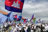 A political rally where Cambodian people wear white shirts and wave the Cambodian flag.