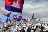 A political rally where Cambodian people wear white shirts and wave the Cambodian flag.