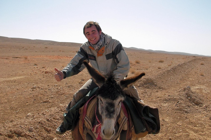 Jeremy hitches a ride on a donkey in Syria.