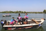 The Bad Habit fishing team in their boat on the Corroboree Billabong