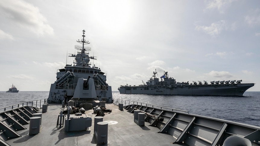 A warship with others in the distance.