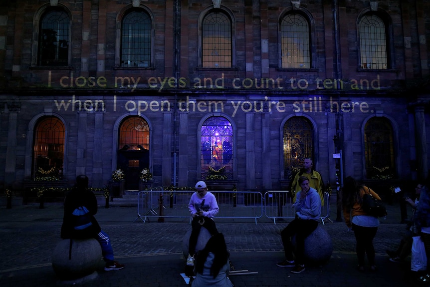 Words are projected onto a church marking the first anniversary of the Manchester Arena bombing.