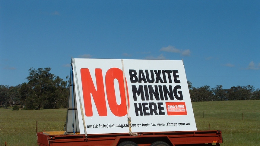 Signs display community opposition to proposed bauxite mine