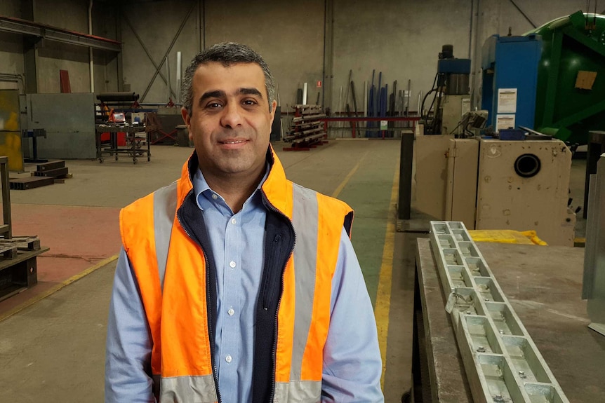 A man wearing an orange and silver high-vis vest.