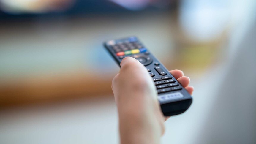 A person holding a remote control.