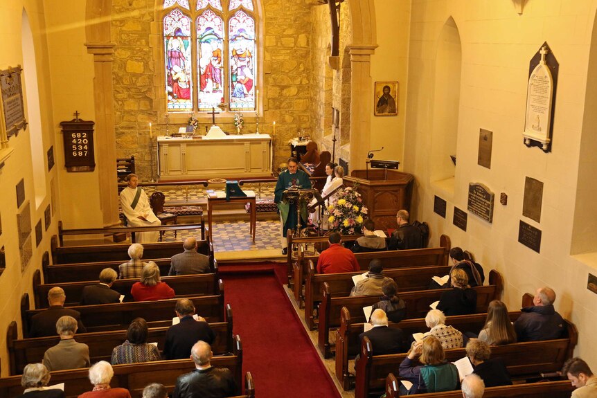 Reverend Paul Black reads out the prepared apology at St John's in Reid, ACT.