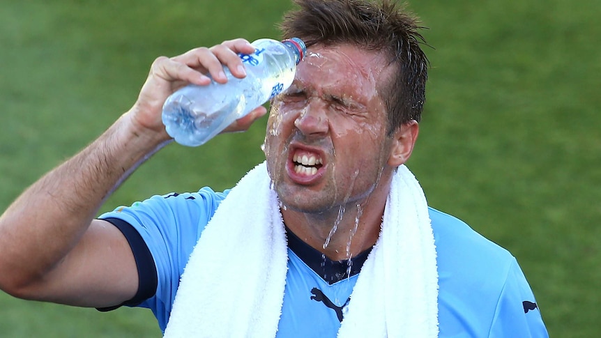 Sydney FC's Milos Dimitrijevic cools off with water bottle